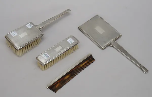 A lady's silver mounted four piece composite dressing set, comprising; a hand mirror, a hair brush, a clothes brush and a comb, Birmingham 1962, 1963