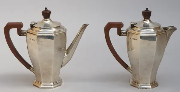 A silver two piece cafe au lait set, comprising; a coffee pot and a hot milk jug, each piece of tapered octagonal form, with brown composition fitting