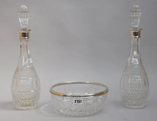 A silver mounted faceted glass circular salad bowl, decorated with a beaded rim, Birmingham modern and a pair of silver mounted, faceted glass decante