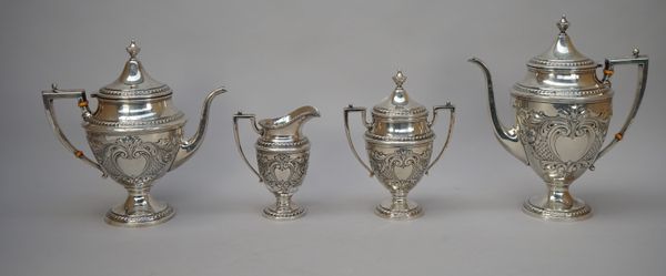 A Sterling silver five piece tea and coffee set, comprising; a teapot, a coffee pot, a twin handled lidded urn shaped vessel, a sugar bowl and a milk