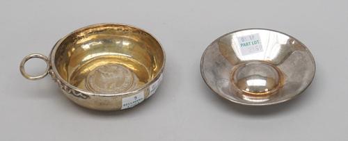 A French tasse de vin, of circular form, with a serpentine handle, mounted to the centre of the bowl with a Chile one peso 1875 (the marks worn) and a