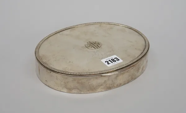 An oval hinge lidded trinket box, the cover initial applied and having a foliate border, textile lined within, detailed 800, length 21cm.