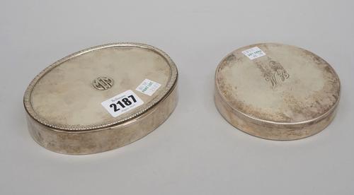 An oval hinge lidded box, the front initial applied, within a foliate border, detailed 800, length 14cm, lined within and a circular box, the cover in