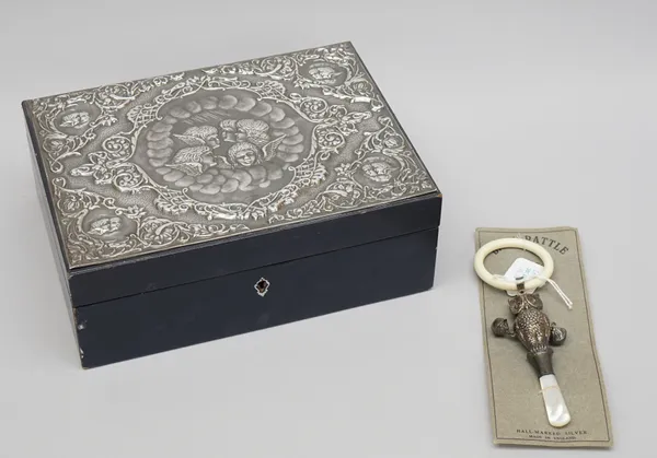 A silver mounted rectangular hinge lidded jewellery box, the fitted interior with a lift-out tray and having a mirror to the lid, the exterior top emb