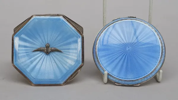 A silver and enamelled lady's octagonal powder compact, fitted with a mirror within, the lid applied with a badge of The Royal Air Force, on a pale bl
