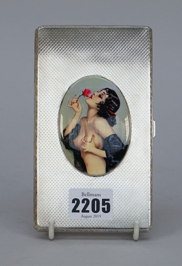 A silver rectangular cigarette case, the front later applied with an oval enamelled plaque, depicting the portrait of a semi clad lady, with black hai