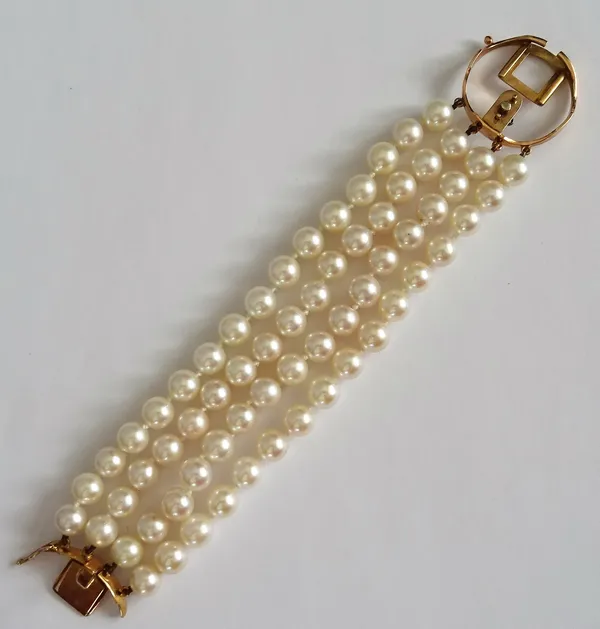 A four row bracelet of uniform cultured pearls, on a gold snap clasp, (the central gem set section of the clasp lacking), length 16cm.