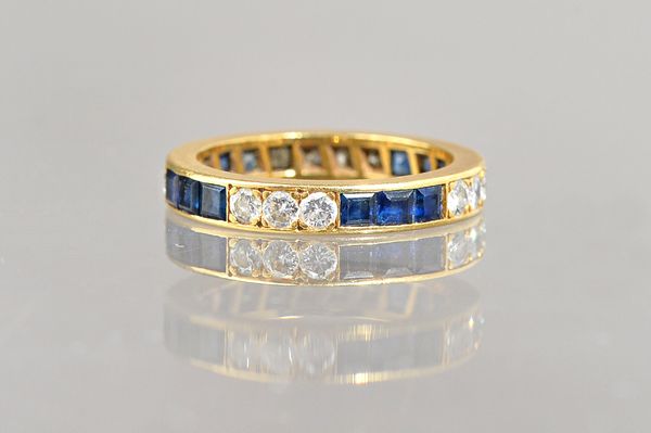 A gold, sapphire and diamond full eternity ring, mounted with rows of calibre cut sapphires, alternating with rows of circular cut diamonds, ring size