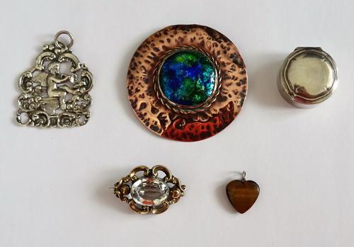A Victorian rock crystal set single stone shaped oval brooch, a blue/green enamelled and copper circular brooch, in an Arts & Crafts inspired design,