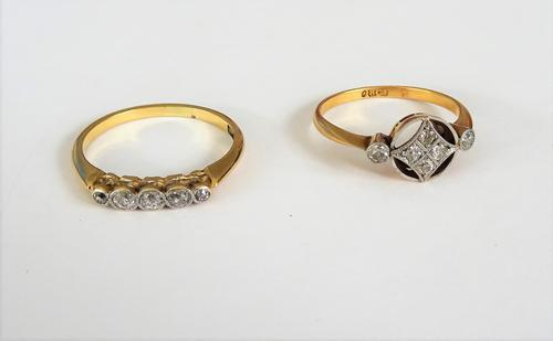A gold and diamond set five stone ring, collet set with a row of cushion shaped diamonds, graduating in size to the centre stone, detailed 18 CT, ring