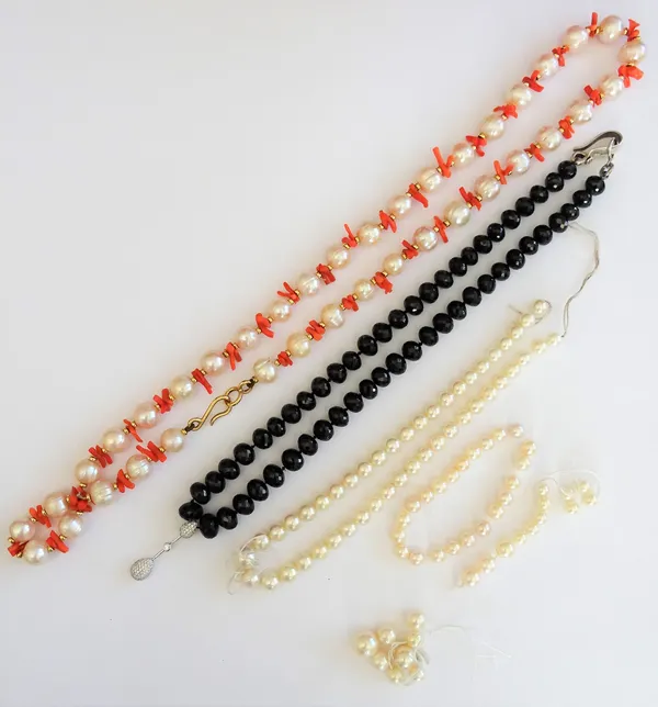 A single row necklace of faceted black glass beads, the front with a diamond set pendant drop, a single row necklace of cultured pearls, with branch c