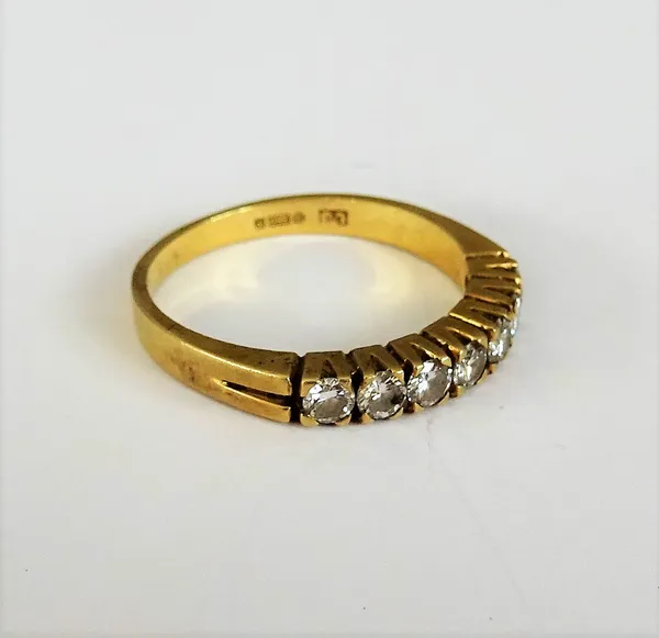 An 18ct gold and diamond set seven stone half hoop ring, mounted with a row of circular cut diamonds, detailed 750, ring size O and a half, gross weig