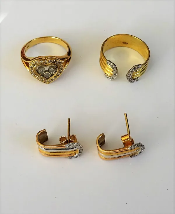 A gold and diamond ring, in a heart shaped design, between split shoulders, detailed 750 18 K and a gold and diamond set ring, in a fluted band design