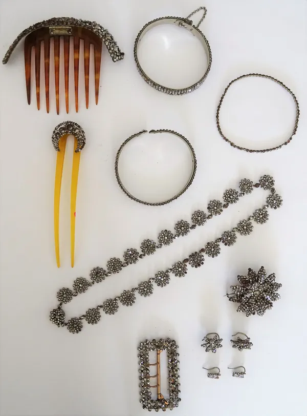 A collection of ten pieces of Victorian cut steel jewellery, comprising; a cluster link necklace, a rectangular buckle, a brooch formed as a flowerhea