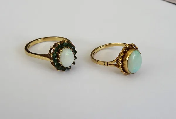 A 9ct gold, opal and emerald oval cluster ring, claw set with the oval opal in a surround of circular cut emeralds, ring size O and a 9ct gold ring, c