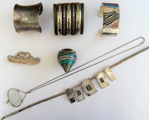 An oval intaglio pendant, in a classical chariot scene design, with a silver neckchain, on a boltring clasp, with a box, a silver brooch, in a classic