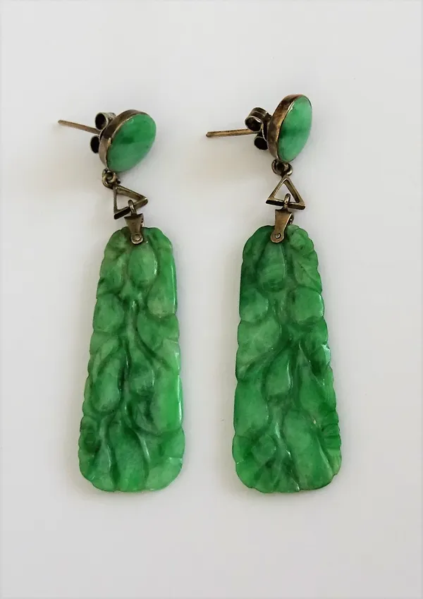 A pair of carved jade pendant earrings, each having a tapered drop carved with fruit and with a circular jade surmount, the tops with post and butterf