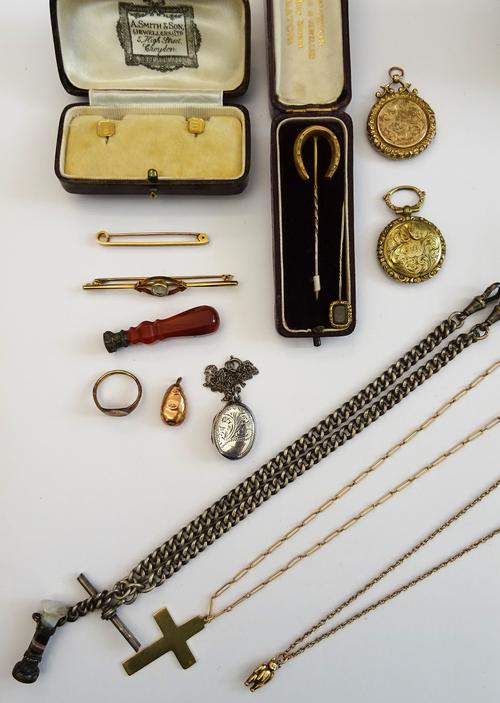 A group of jewellery,comprising; a gold pendant cross with a gold neckchain, a 9ct gold teddy bear pendant, with a neckchain, a pair of gold studs, de