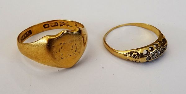 An 18ct gold shield shaped signet ring, Chester 1911, ring size S, weight 3.7 gms. and a gold, diamond and colourless gem set ring (worn) ring size N,