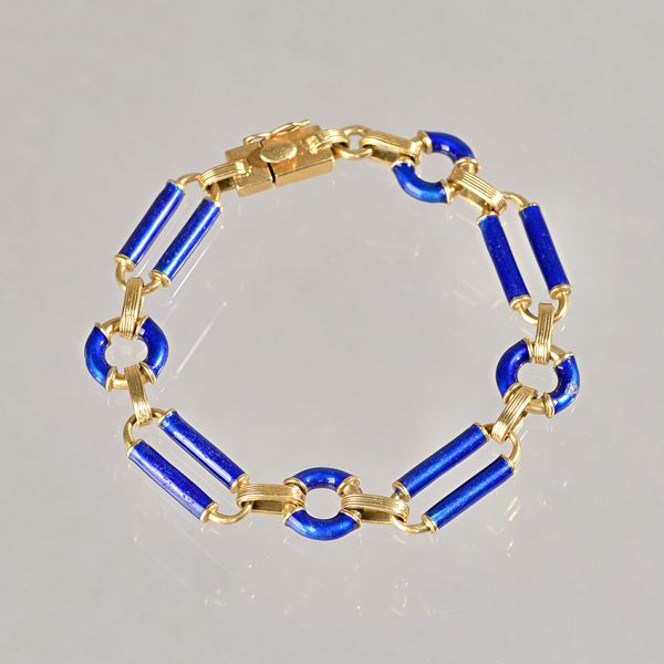 A gold and blue enamelled bracelet, in a circular and bar link design, on a snap clasp, detailed 750, gross weight 29.5 gms. Illustrated.