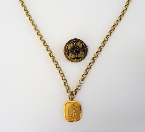 A Victorian gold and carbuncle garnet set circular brooch, with foliate motifs, a 9ct gold St Christopher pendant and a 9ct gold circular link neckcha