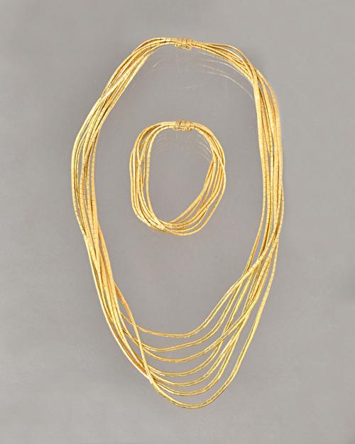 An 18ct gold necklace, in a seven row graduated link design, having a brushed finish, with a foldover safety catch and an 18ct gold bracelet, in a sim