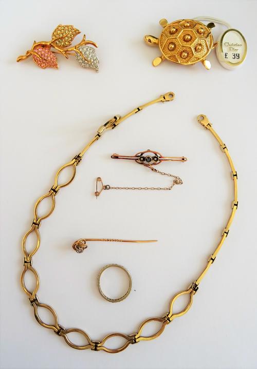 A 9ct two colour gold oval link collar necklace, with a sprung hook shaped clasp, gross weight 18.2 gms, a colourless gem set eternity ring, a 9ct gol