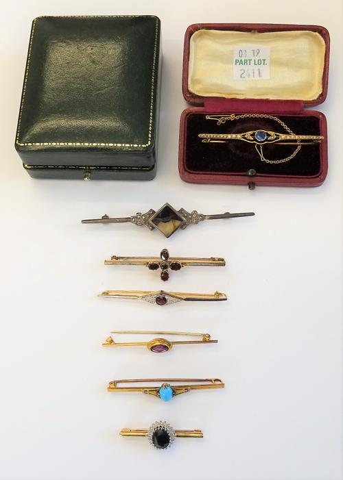 A gold, sapphire and seed pearl set bar brooch, fitted with a safety chain, with a case, a gold bar brooch, mounted with an oval cut amethyst, a garne