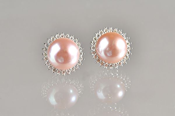 A pair of white gold, diamond and culutred pearl earstuds, each mounted with a large cultured pearl to the centre, within a surround of small circular
