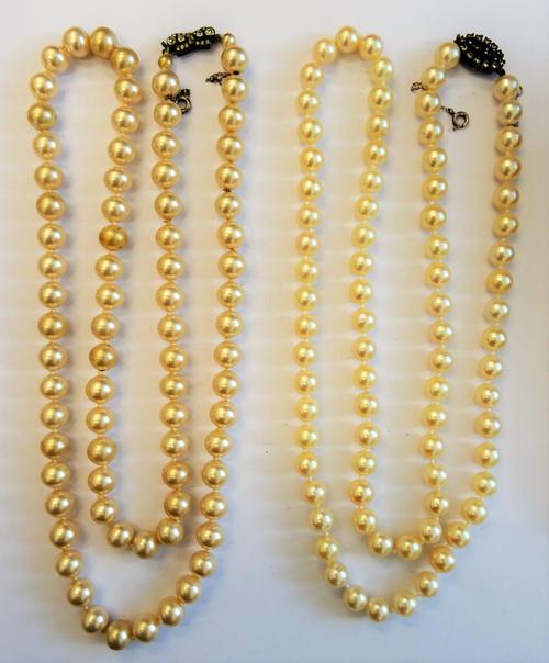 A single row necklace of uniform cultured pearls, on a blue  and colourless paste set clasp, length including clasp 71.5cm, with a case and a single r