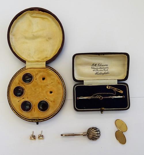 A gold and platinum fronted, ruby and diamond set five stone bar brooch, detailed 9 CT, fitted with a safety chain, with a case, a part set of four dr