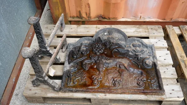 An 18th century arch top cast iron fire back with heraldic lion and two matching fire dogs, 77cm wide x 69cm high.