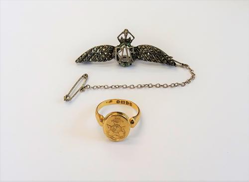 An 18ct gold oval ring, hinged with a locket compartment, the front engraved First Surrey Rifles 21 County of London, Chester 1915, ring size J and a