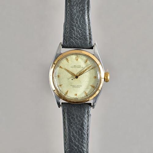 A Rolex Oyster Perpetual steel and gold cased gentleman's wristwatch, the signed silvered dial with gilt arrow shaped numerals, Rolex crown at 12 o'cl