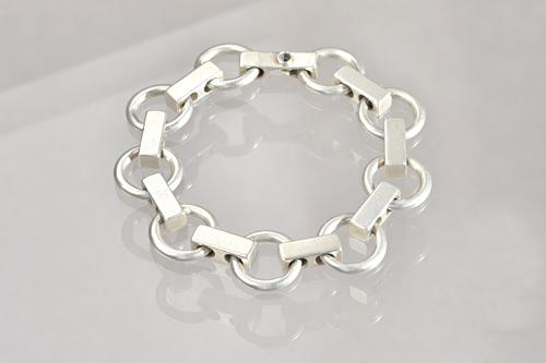 A silver bracelet, in a circular and bar link design, detailed Denmark Sterling Bentk 60, weight 55.5 gms. Illustrated.