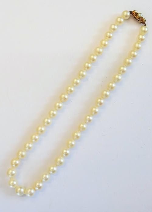 A single row necklace of uniform cultured pearls, on a 9ct gold and cultured pearl set clasp, length including clasp 38cm, with a case.