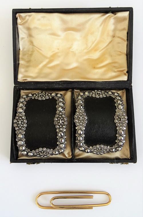 A 9ct gold money clip, designed as a paper clip, London 1966, weight 10 gms and a pair of cut steel buckles, of curved rectangular form, with a case,