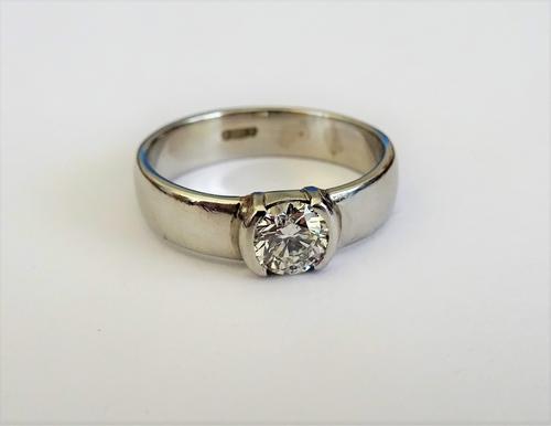 A platinum and diamond set single stone ring, mounted with a circular cut diamond, ring size J, with a G I A diamond dossier stating the diamond to we