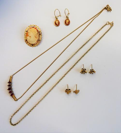 A gold, ruby and diamond necklace, mounted with five marquise shaped rubies, alternating with four pairs of circular cut diamonds in a curved design,