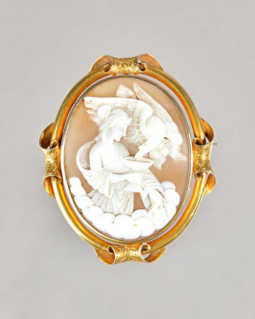 A Victorian gold mounted, oval shell cameo brooch, carved as a classical female figure, with an eagle, the mount with four scrolled motifs at interval