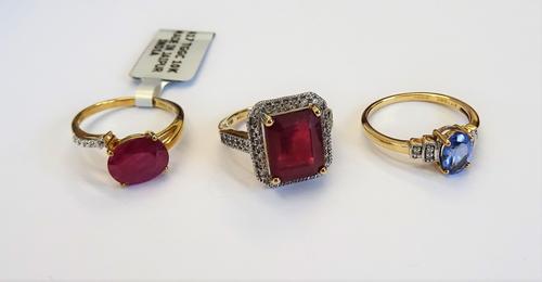 A 9ct gold, red and colourless gem set rectangular cluster ring, a 9ct gold oval cut treated ruby and colourless gem set ring and a 9ct gold ring, cla