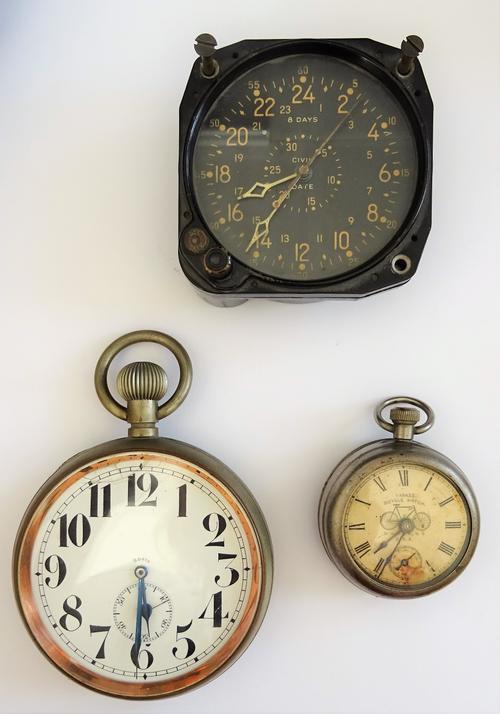 A circular black clock, detailed to the black dial 8 DAYS CIVIL DATE U.S NAVY BU.AERO WALTHAM and to the caseback Waltham Watch Co, a base metal cased