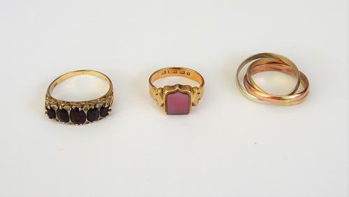 A 9ct three colour gold Russian style wedding ring, ring size S and a half, weight 5.2 gms, a 9ct gold and garnet set five stone ring, mounted with a
