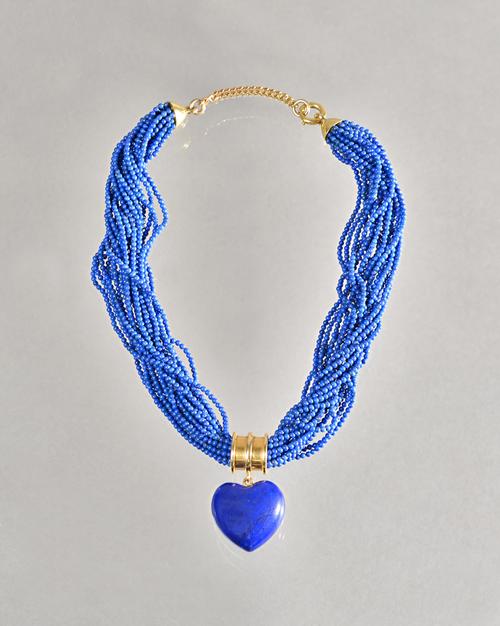 A gold and lapis lazuli necklace, formed as a multiple row spherical bead collar, the front fitted with a goldmounted,lapis lazuli heart shaped pendan
