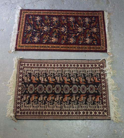 A Baluchistan rug, the black field with stylized flowerheads, large peacocks and other birds; a minor flower border, 156cm x 85cm and a Baluchistan ru