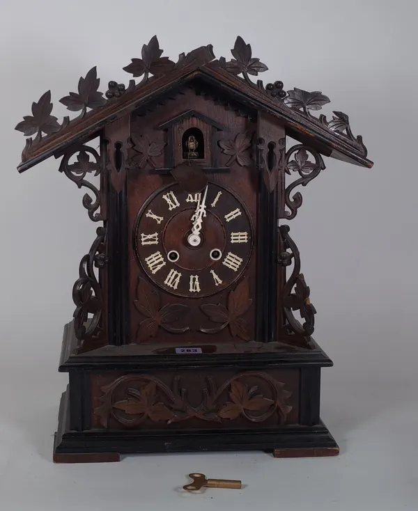 A late 19th century walnut cased cuckoo clock (pendulum).