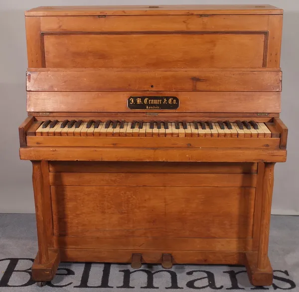 An early 20th century pine child's upright piano, 94cm wide x 107cm high.