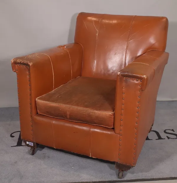 An early 20th century tan leather upholstered club armchair.