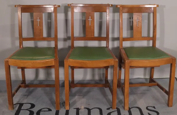 A set of eight 20th century walnut chapel chairs with green faux leather drop in seats, (8).