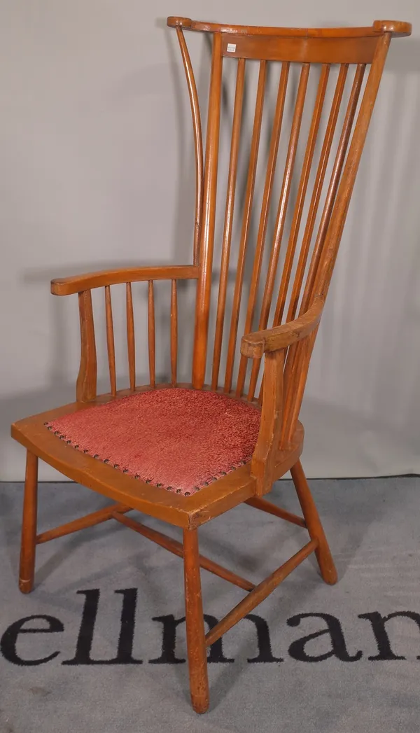 An early 20th century beech stick back armchair on tapering supports.